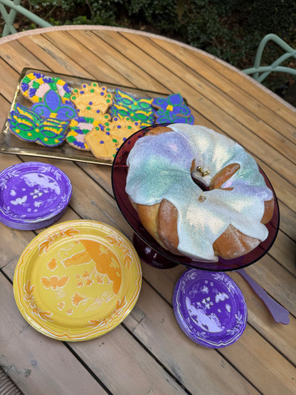 Colorful paper plates and bowls on a wooden surface